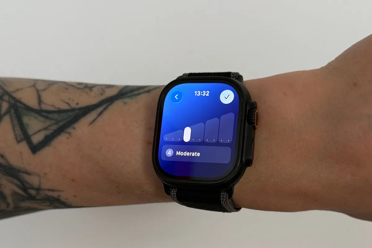 An Apple Watch on a wrist showing the Effort screen after a workout, with the slider set to 4 and labelled Moderate.